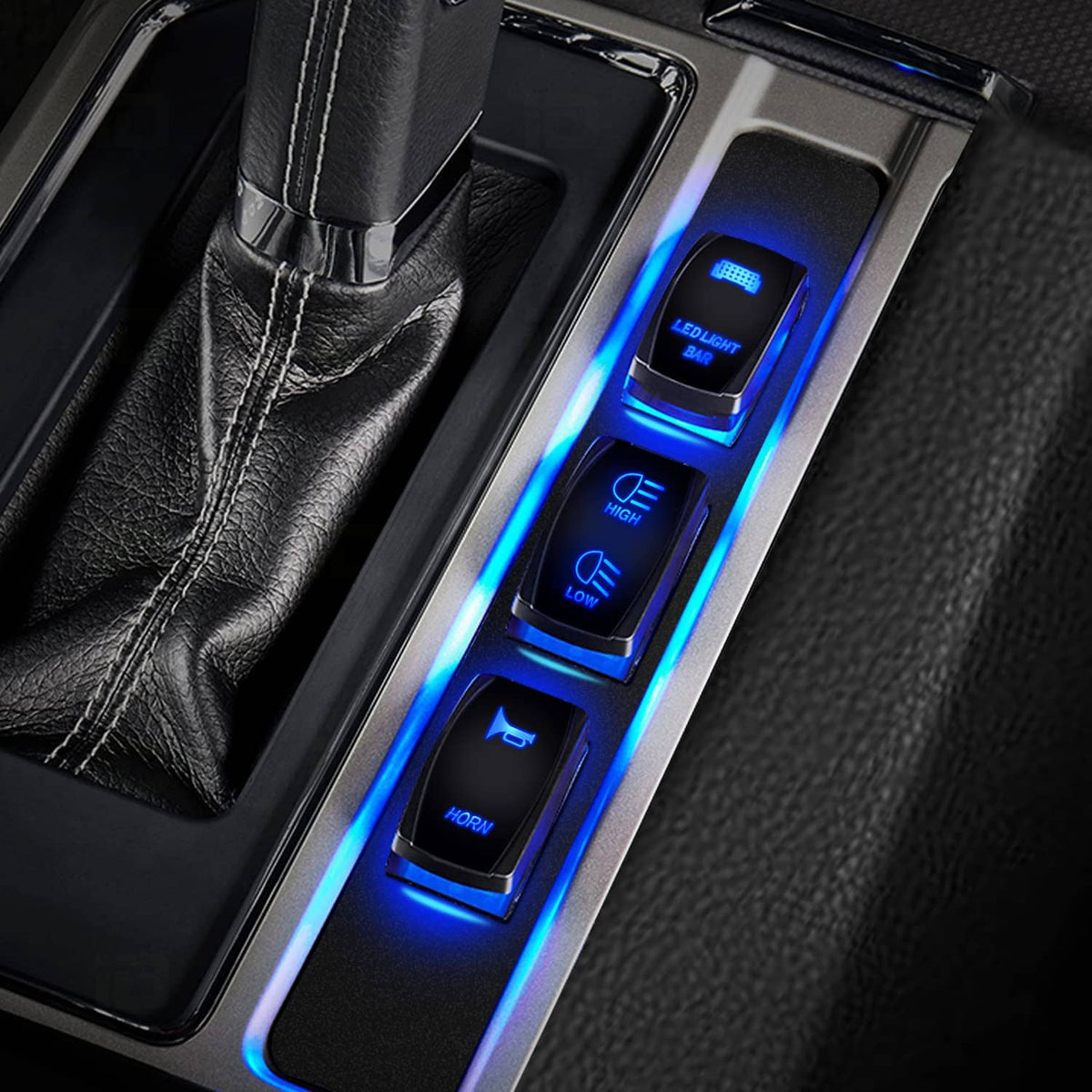 Dashboard rocker switch with blue illuminated HIGH/LOW icons in a vehicle panel