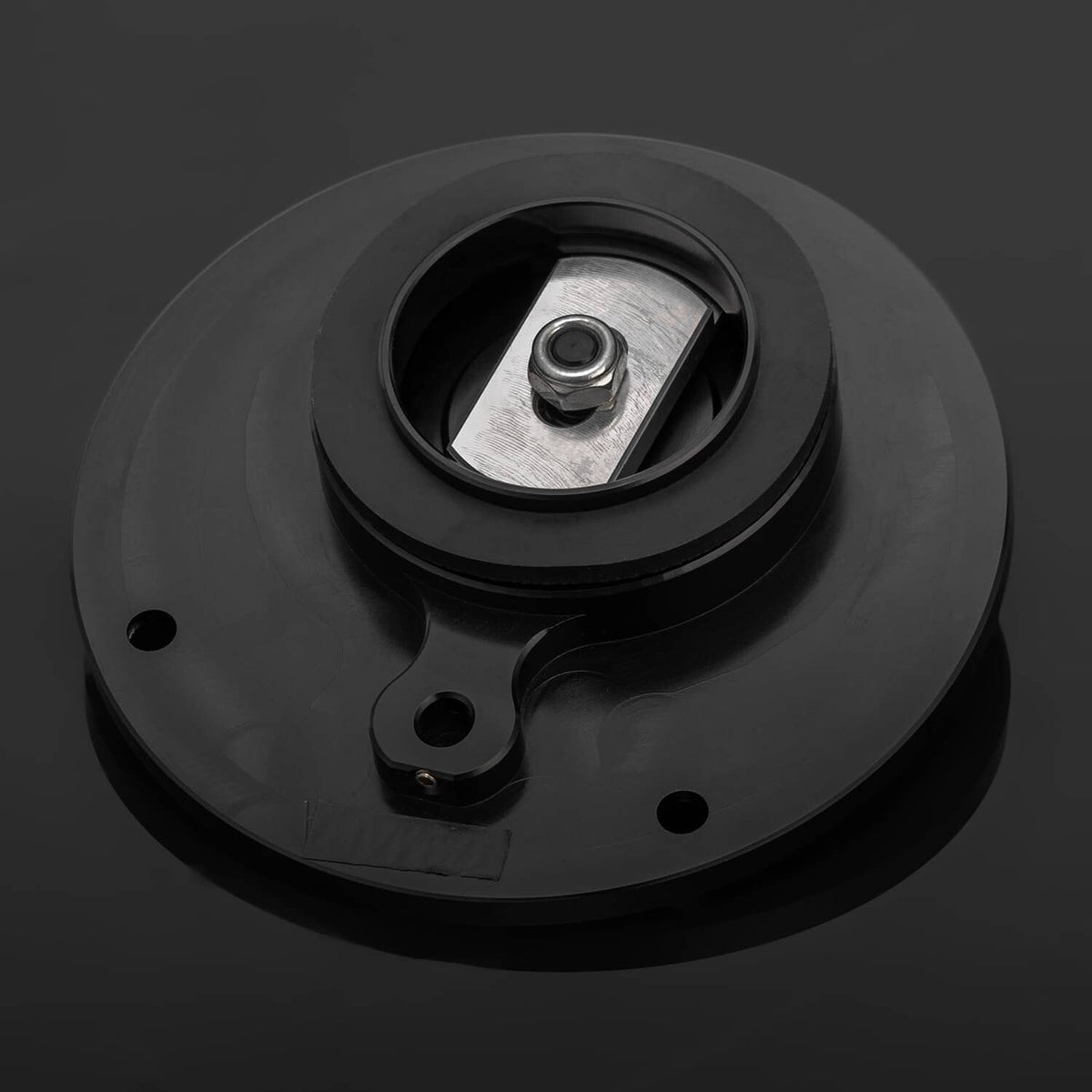 Black fuel tank cap underside with central metal threaded insert and mounting plate