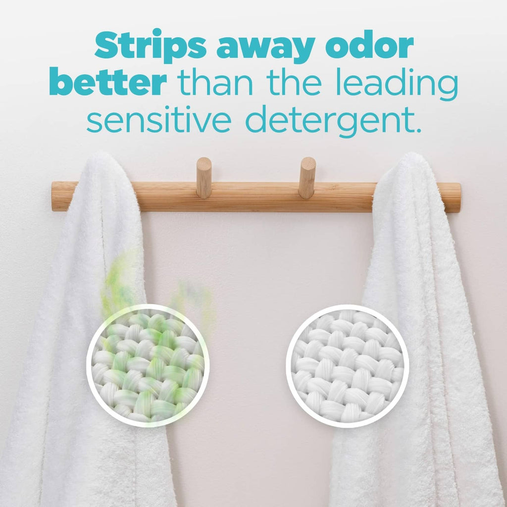 White towels on rack with visible laundry detergent pods beads
