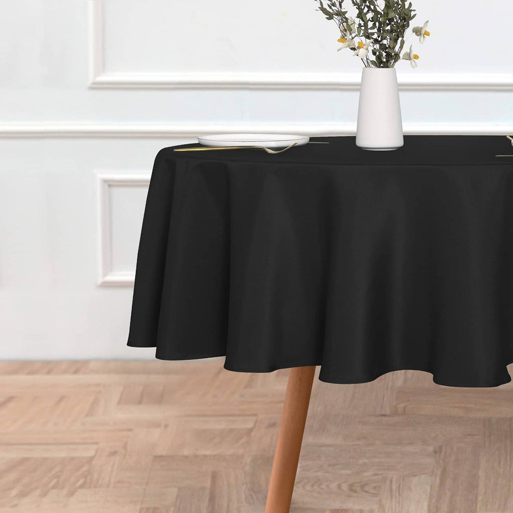 Black round tablecloth with smooth drape over a tabletop