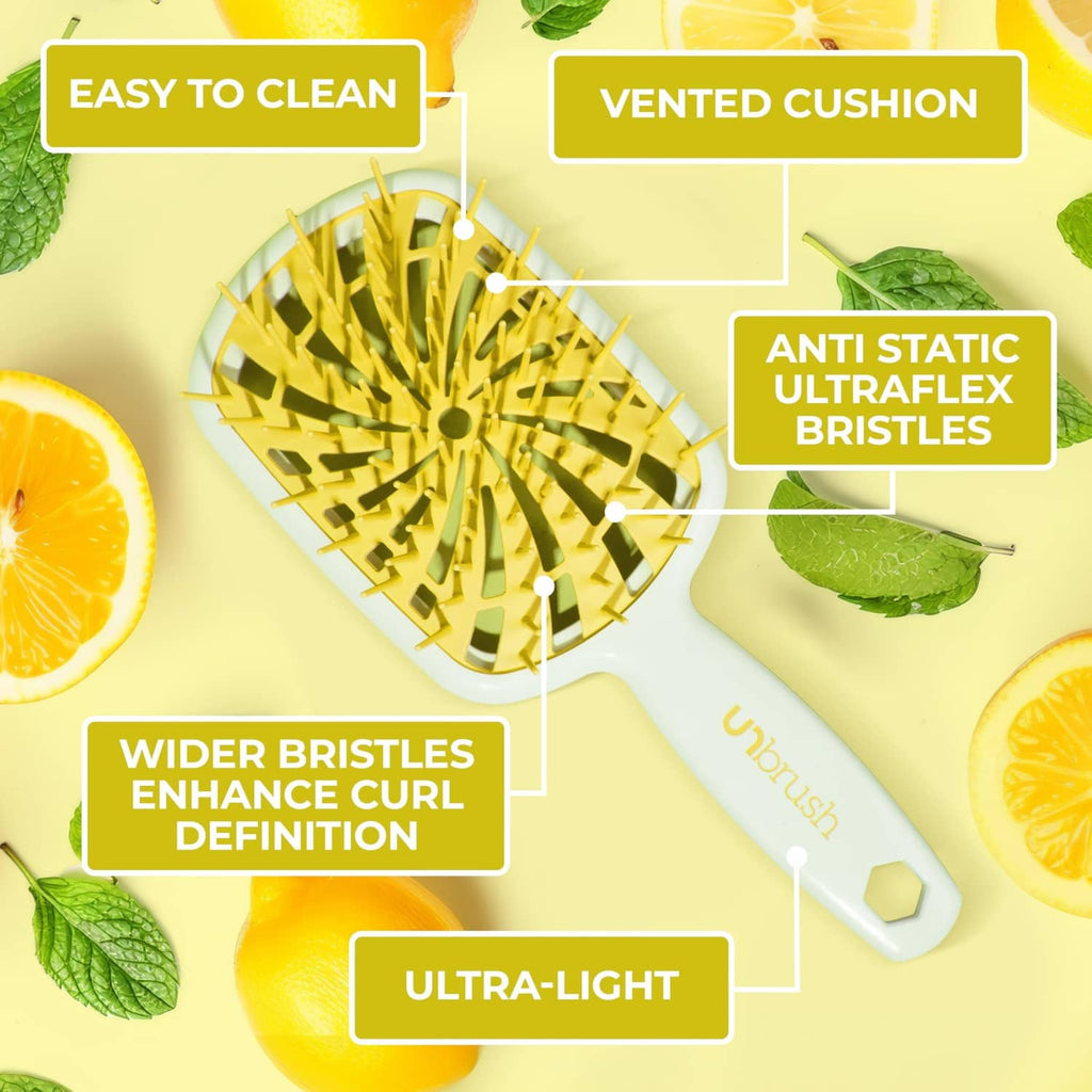 Vented detangling brush with yellow anti-static bristles on white cushioned pad