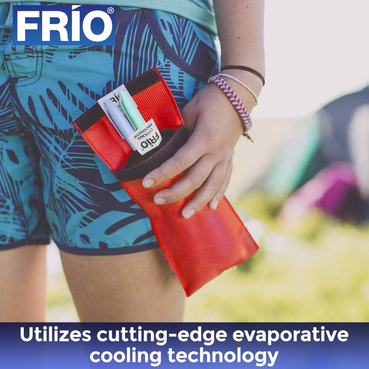 Red FRIO cooling wallet held in hand with slim pen inserts
