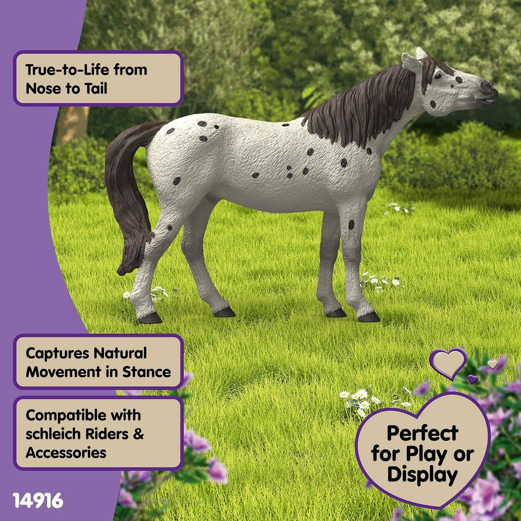 Leopard-spotted horse toy figure with black mane and tail, standing outdoors.