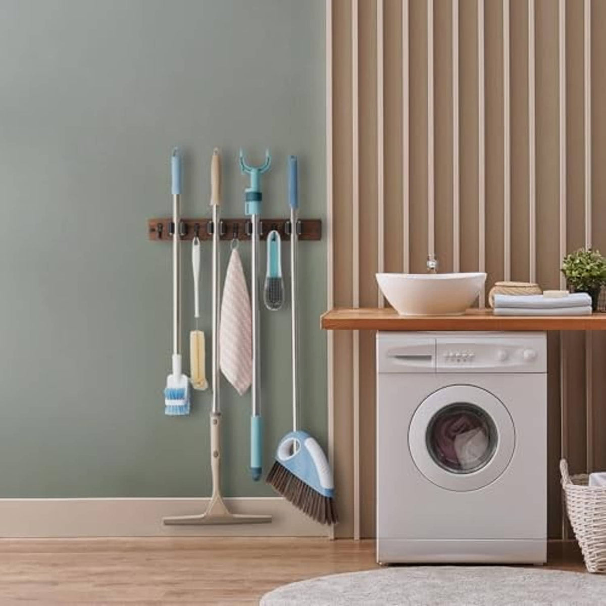 Wall-mounted mop and broom holder rack with wooden rail holding cleaning tools