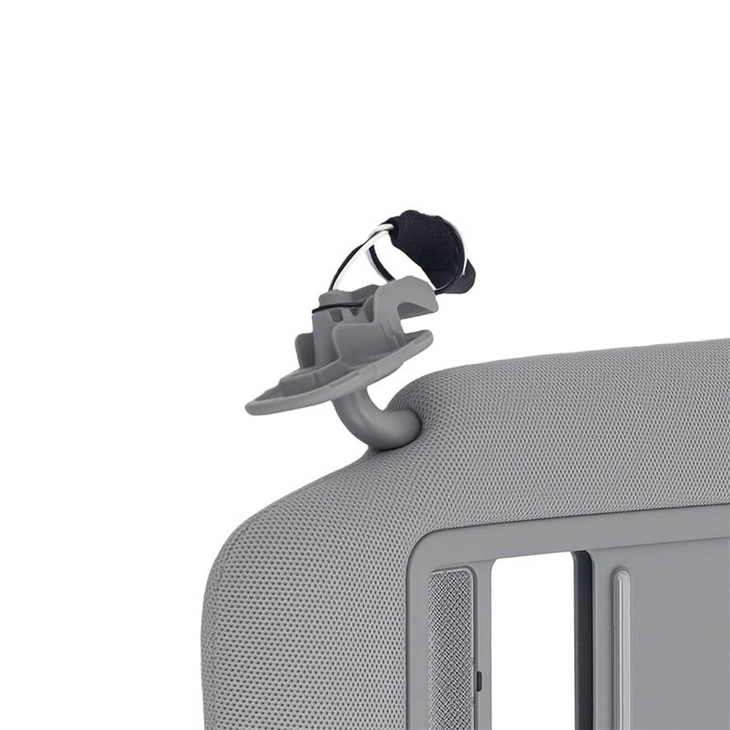 Gray sun visor with visible clips and textured panel near vanity mirror opening