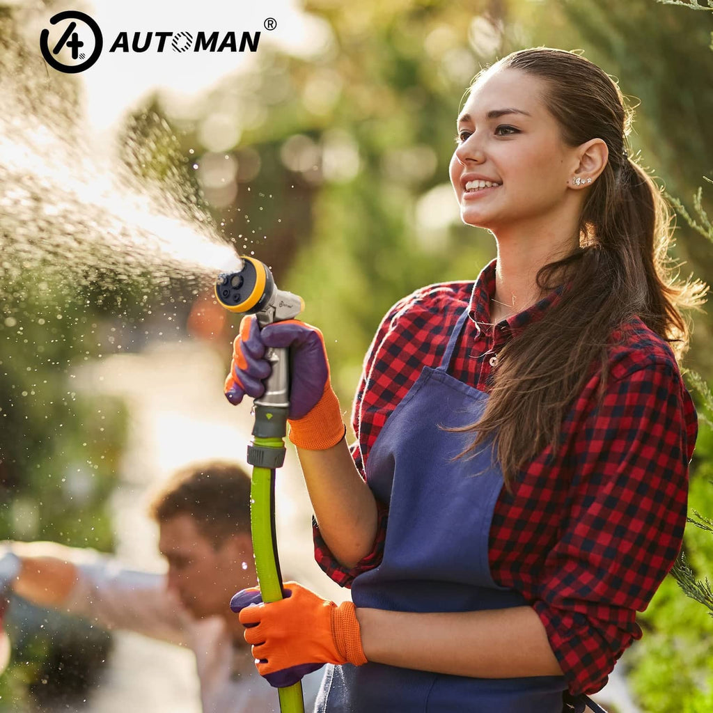 Person holding a silver and yellow high-pressure garden nozzle sprayer with trigger