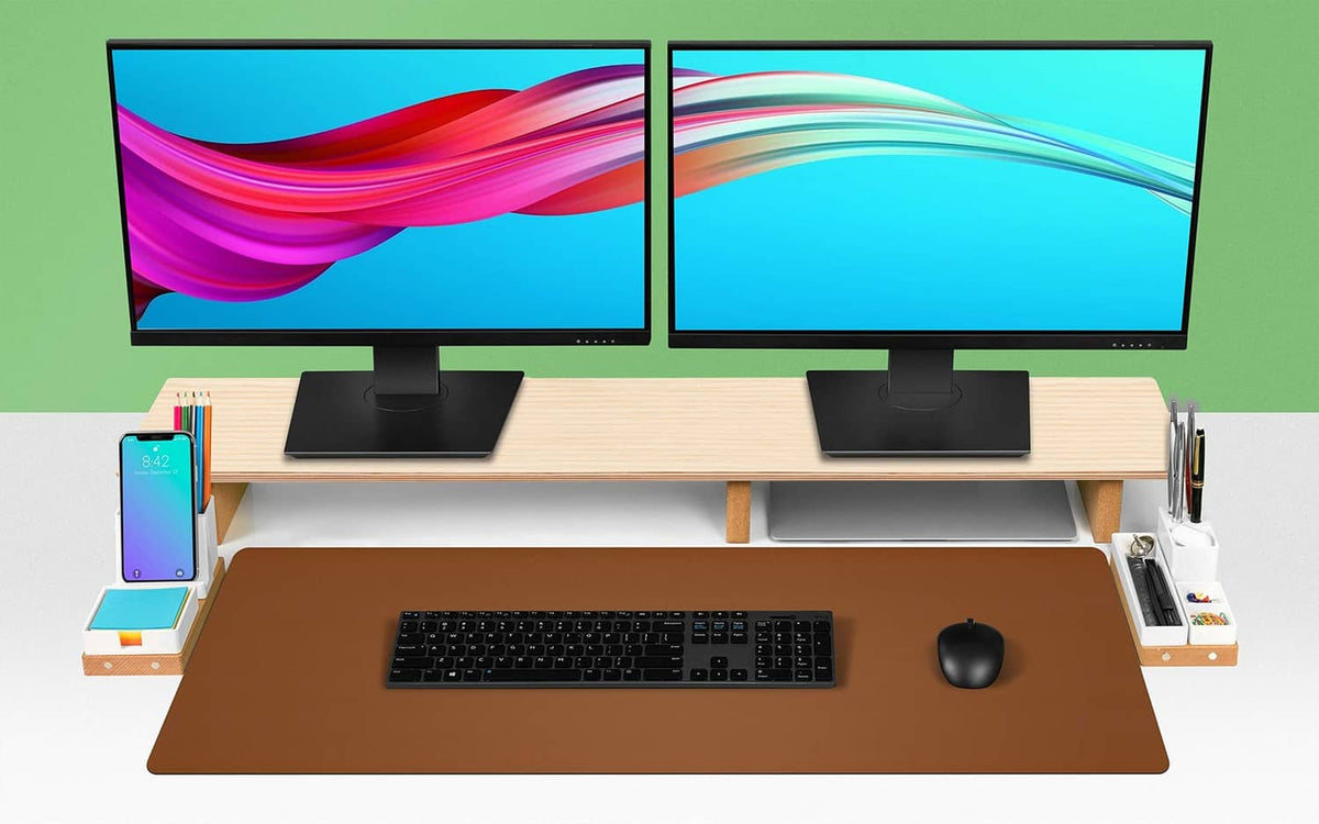 Brown leather desk pad on standing desk with keyboard and mouse in center.