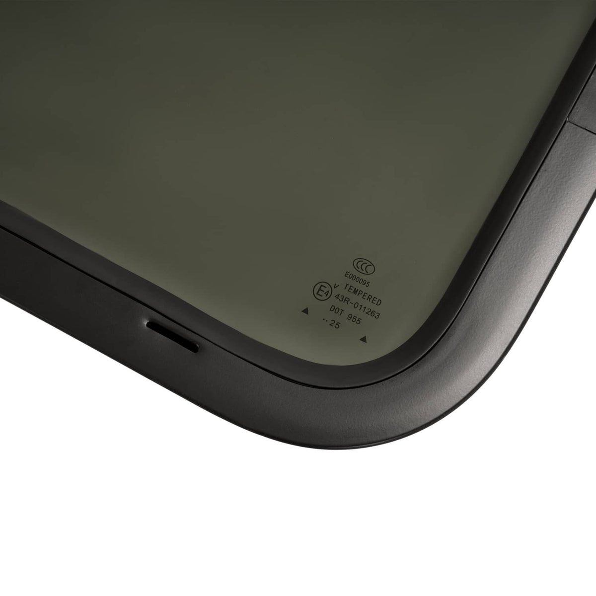Corner view of tinted RV window with rounded black trim and label
