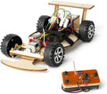 Wooden racing car kit with black off-road wheels, exposed electronics, and remote controller