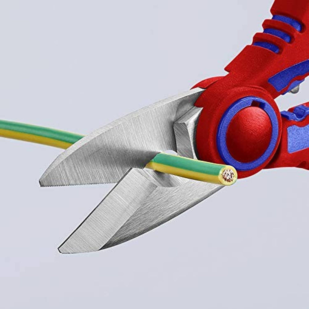 Close-up of electricians' shears blades near crimp area, red and blue handles with tool markings