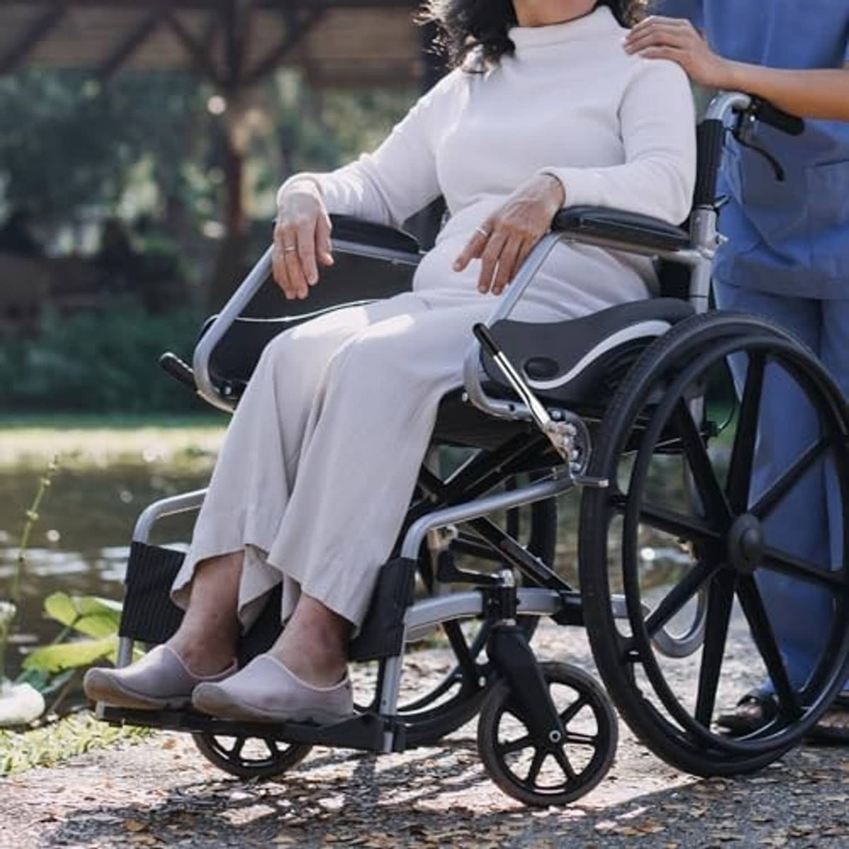 Wheelchair brake lever extender on silver handle with black rubber end cap