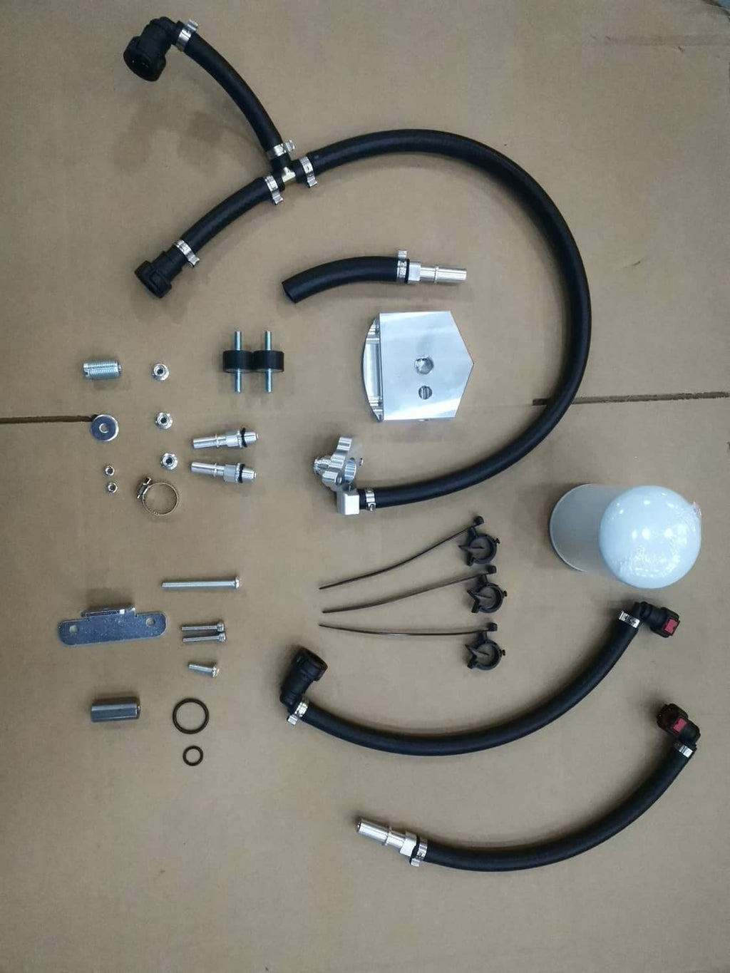 Bypass kit components laid out: black hoses, fittings, metal bracket, and filter canister