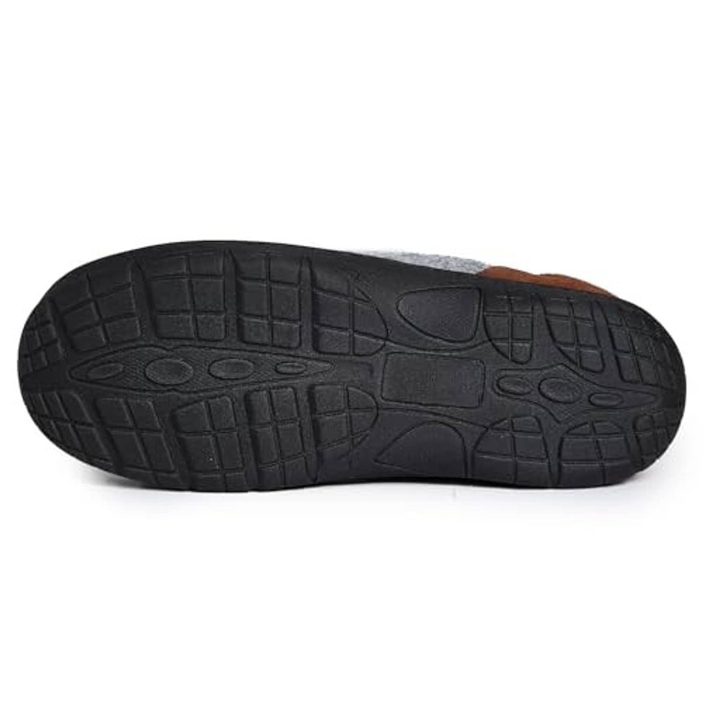 Black treaded outsole of light grey fleece clog slippers with brown edge