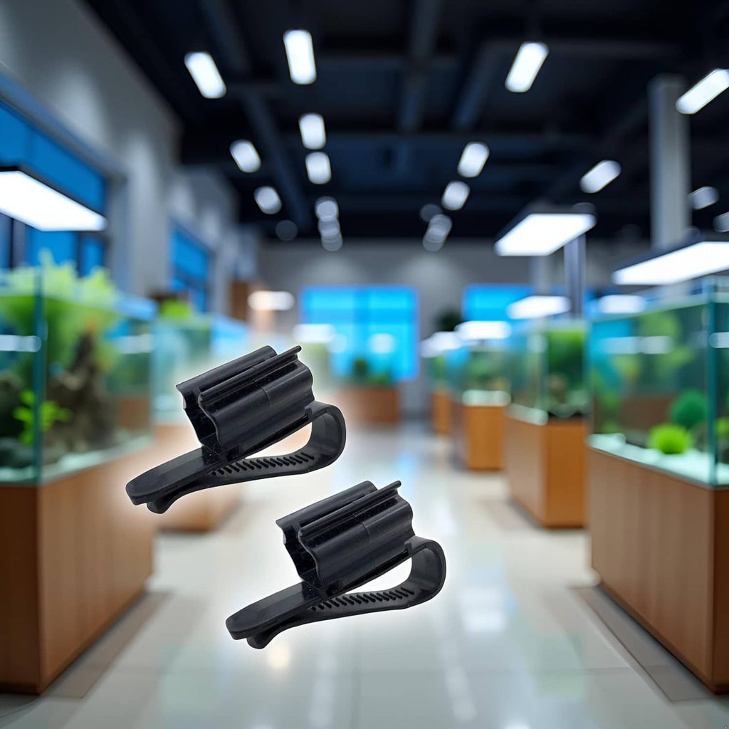 Two black aquarium hose mounting clips with ridged pads and curved clamps