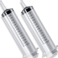 Two clear 150 ml syringes with black measurement markings and gray end caps