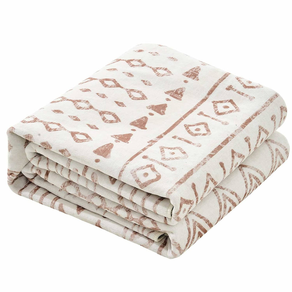 Folded beige rug with brown geometric pattern, stacked fabric bundle