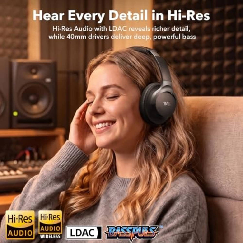 Black over-ear headphones on a person, featuring large padded ear cushions.