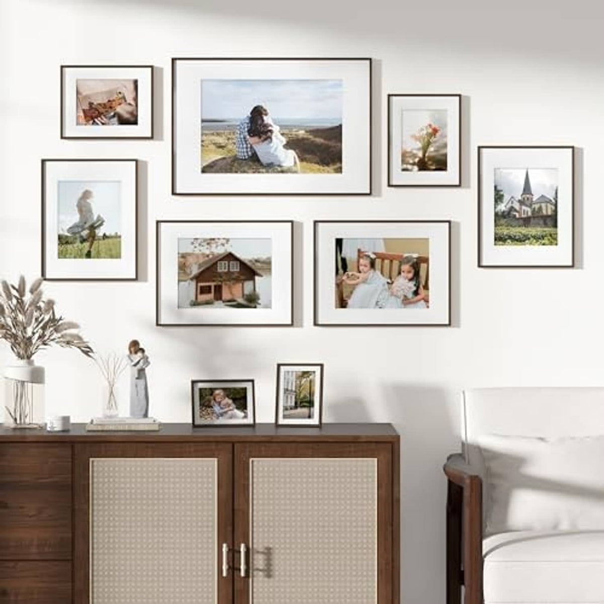 Wall photo display with multiple walnut frames, including 6x8 matted images