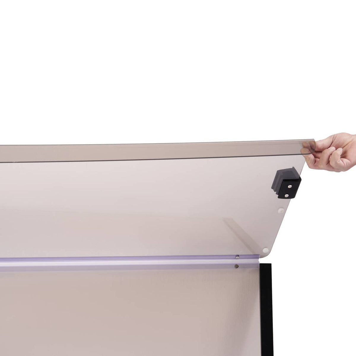 Hand holding tinted golf cart windshield frame with black latch-style bracket