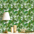Tropical palm leaf peel-and-stick wallpaper with green and white foliage pattern