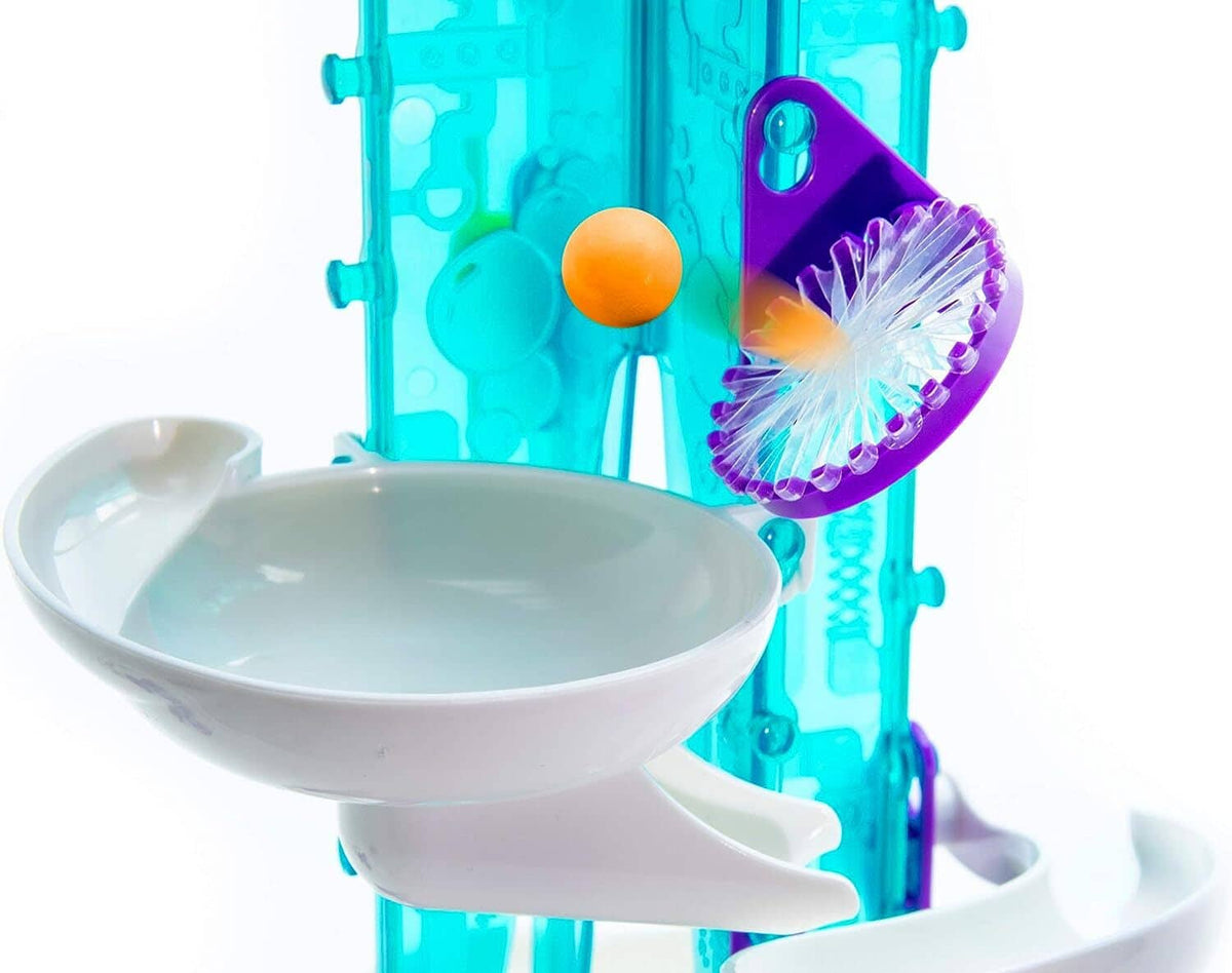 Bubble gum machine bowl with light-blue base and purple spinner scoop holding an orange ball