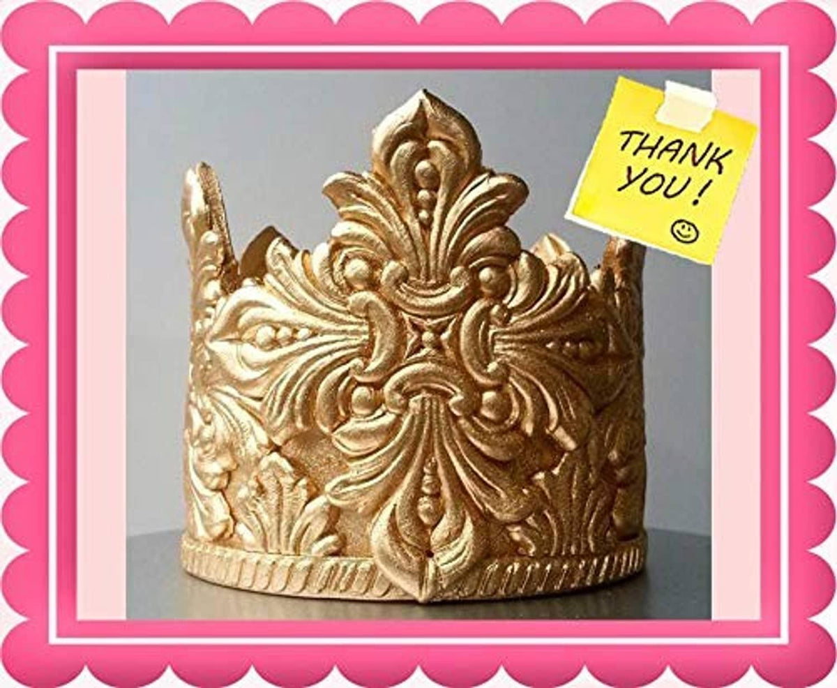 Gold glitter crown cake topper with detailed metallic texture