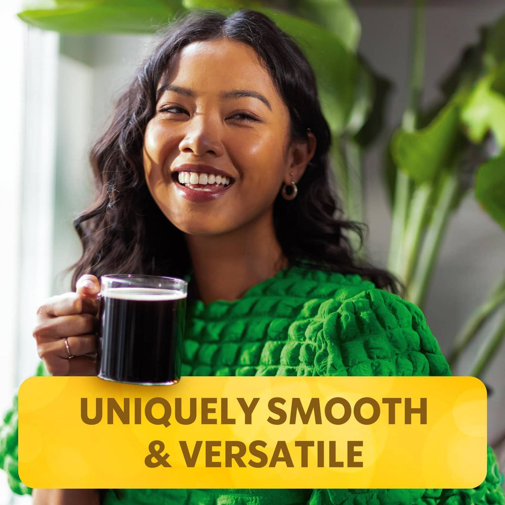 Woman holding a mug of dark coffee with yellow “Uniquely smooth & versatile” banner