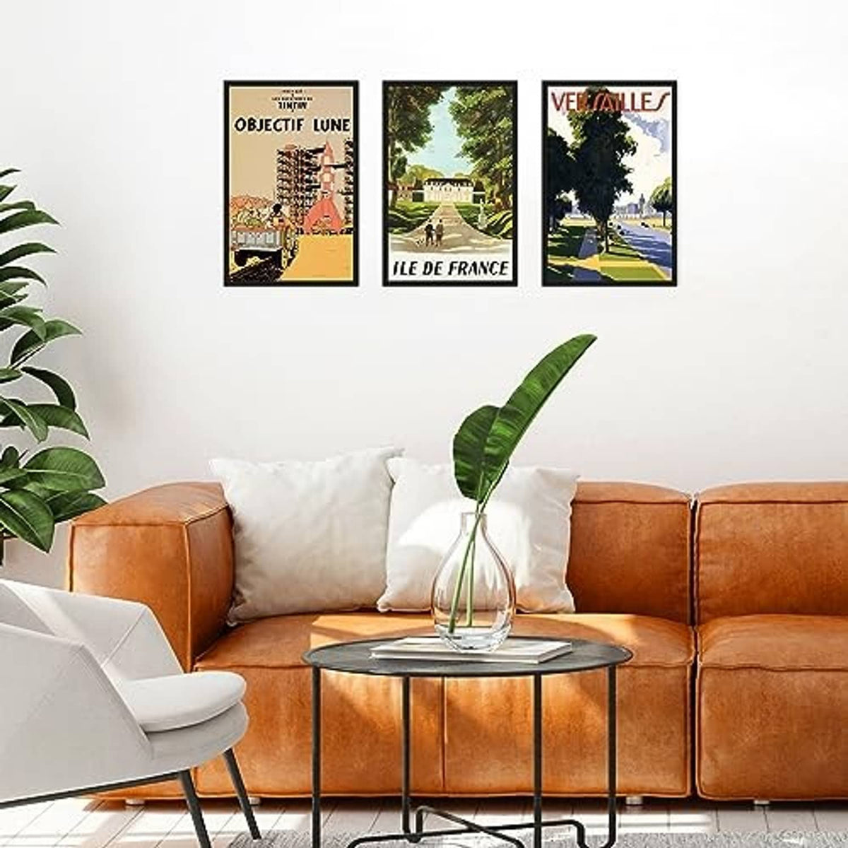 Three black 11x17 poster frames with clear fronts hanging on a wall