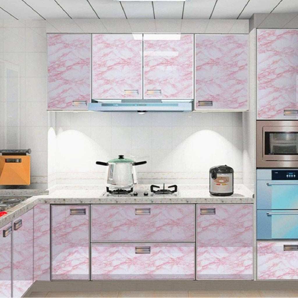 Pink marble peel-and-stick countertop and backsplash panels on kitchen cabinets