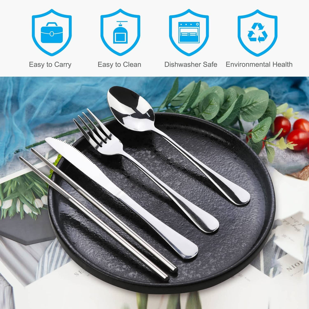 Stainless steel 5-piece cutlery set with spoon and forks beside a round serving plate