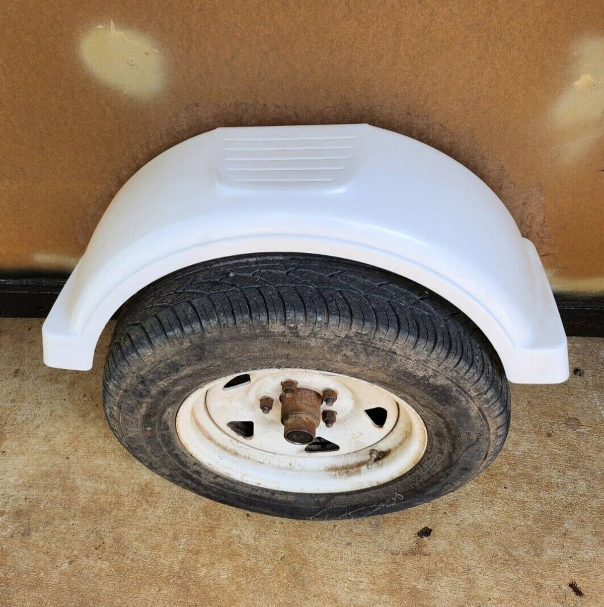 White wheel-arch trailer fender, ribbed top, curved cover over tire