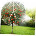 White dome fruit tree protection netting over an apple tree with red fruit