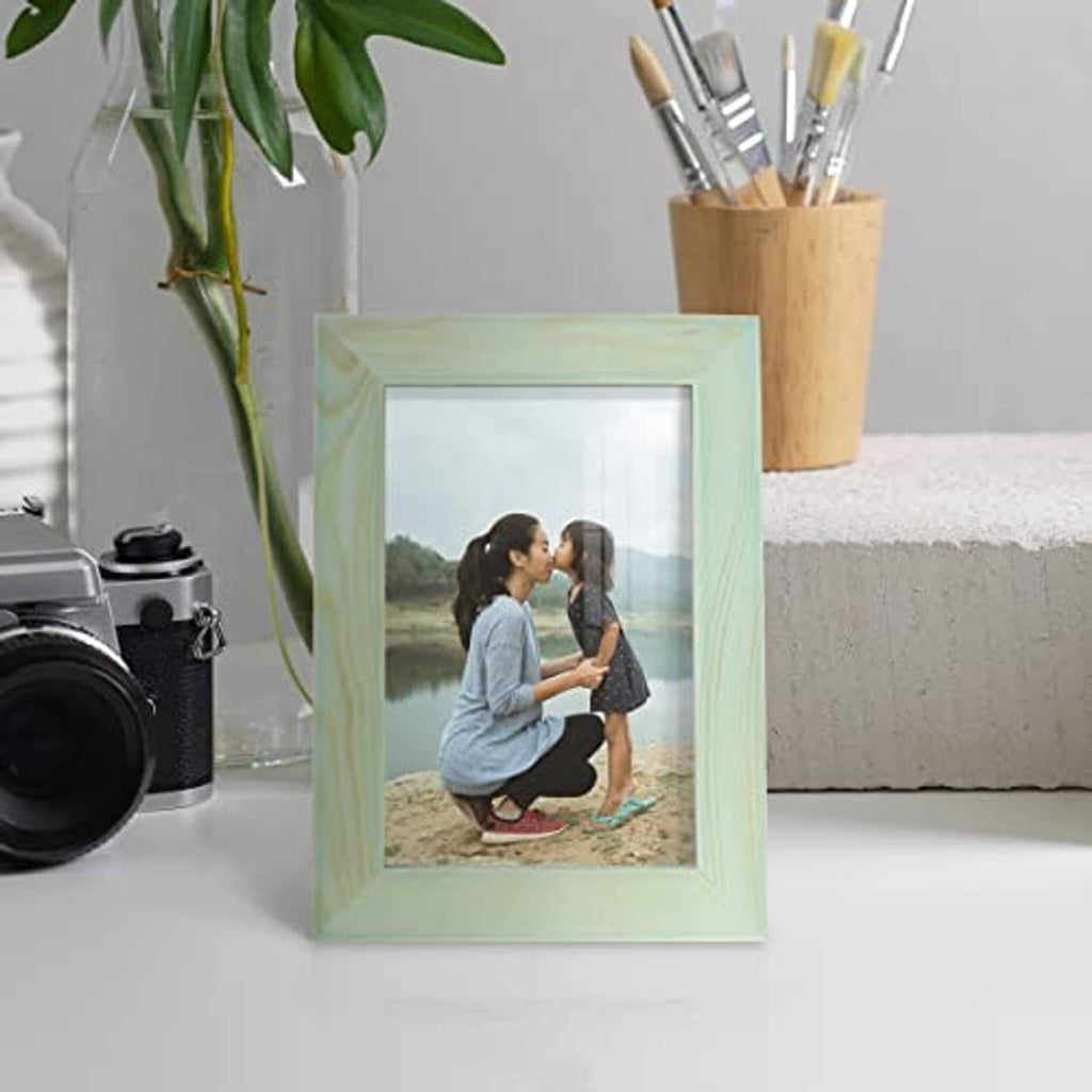 Seafoam green solid wood 4x6 picture frame on tabletop with photo inside