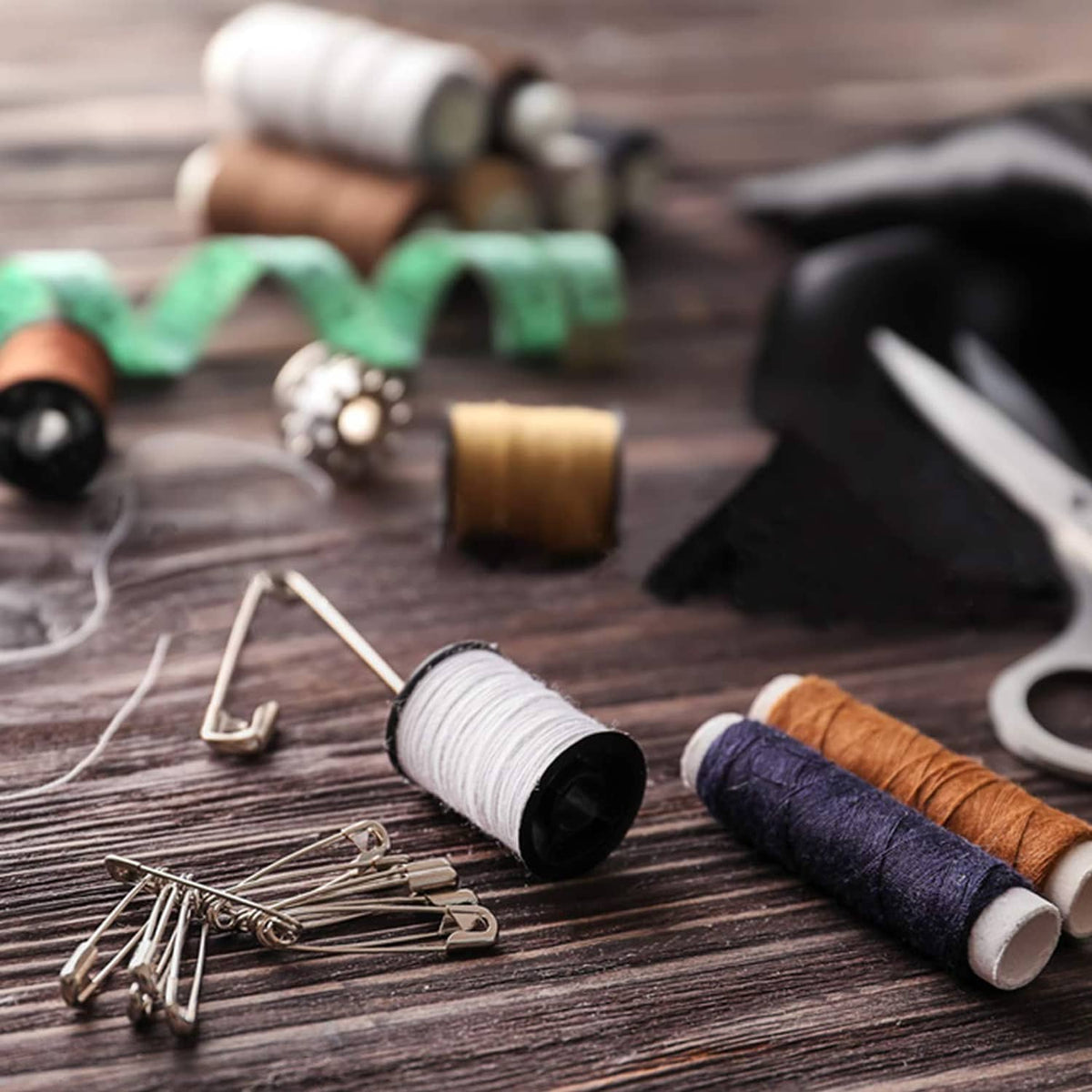 Silver-tone safety pins scattered, metal clasp heads visible
