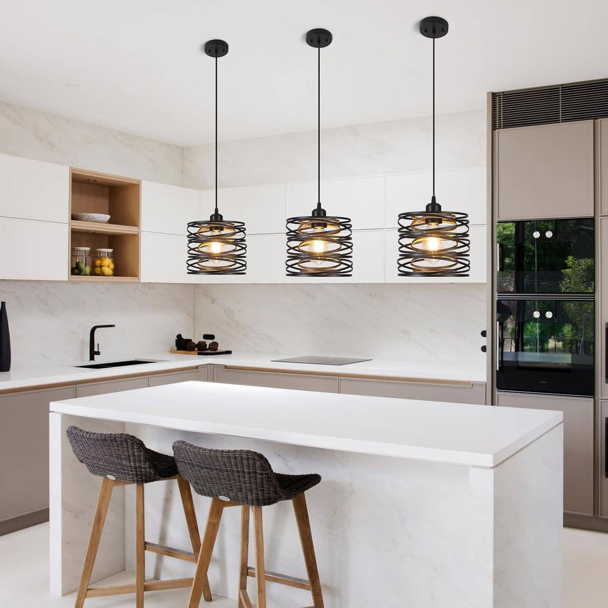Set of three black spiral cage pendant lights hanging above a kitchen island