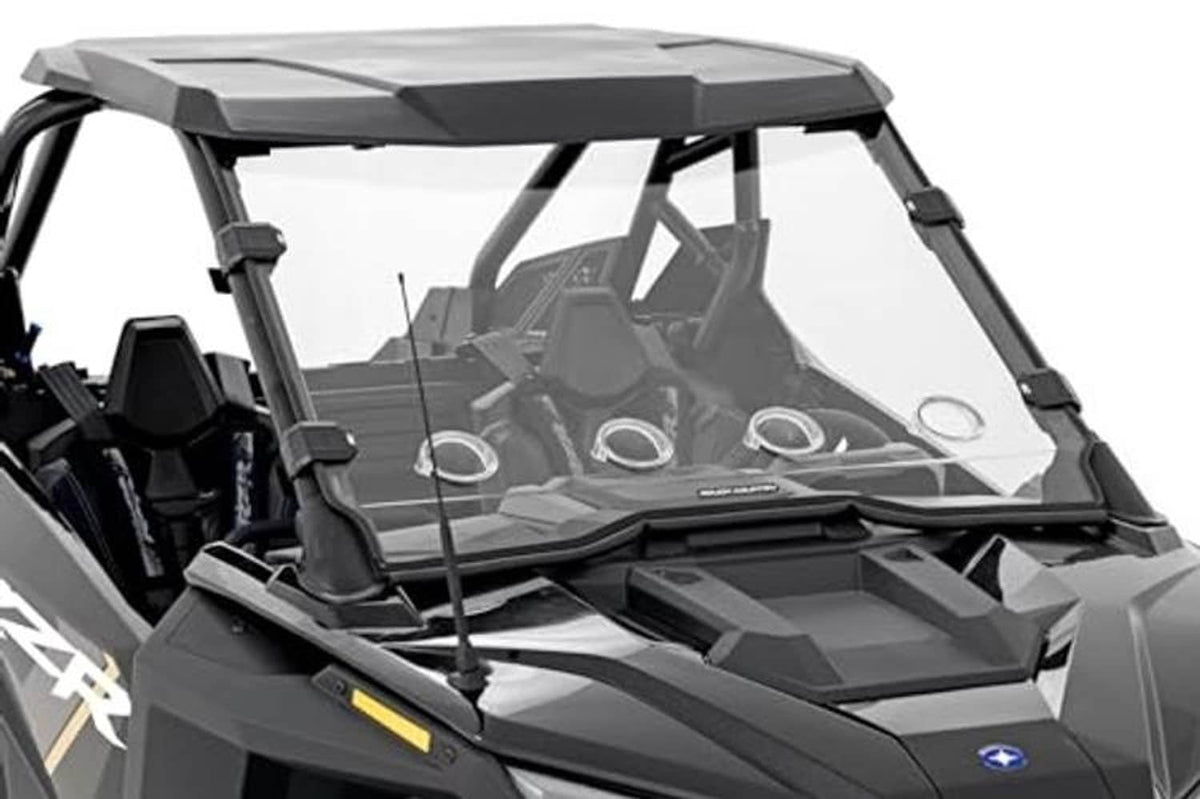 UTV windshield with clear panel and black frame, mounted with side brackets