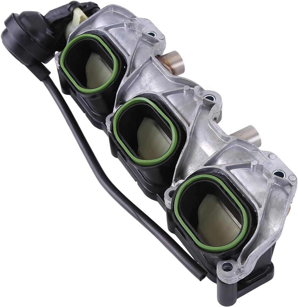 Intake manifold pair close-up; silver intake runners with three green-lined openings and hoses