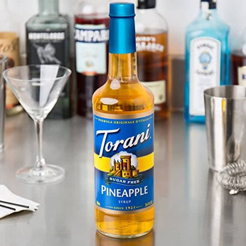 Torani sugar-free pineapple syrup glass bottle with blue cap, yellow syrup and Pineapple label
