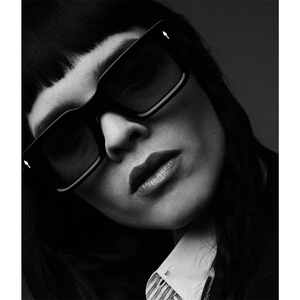 Black thick square sunglasses side view on face with dark lenses