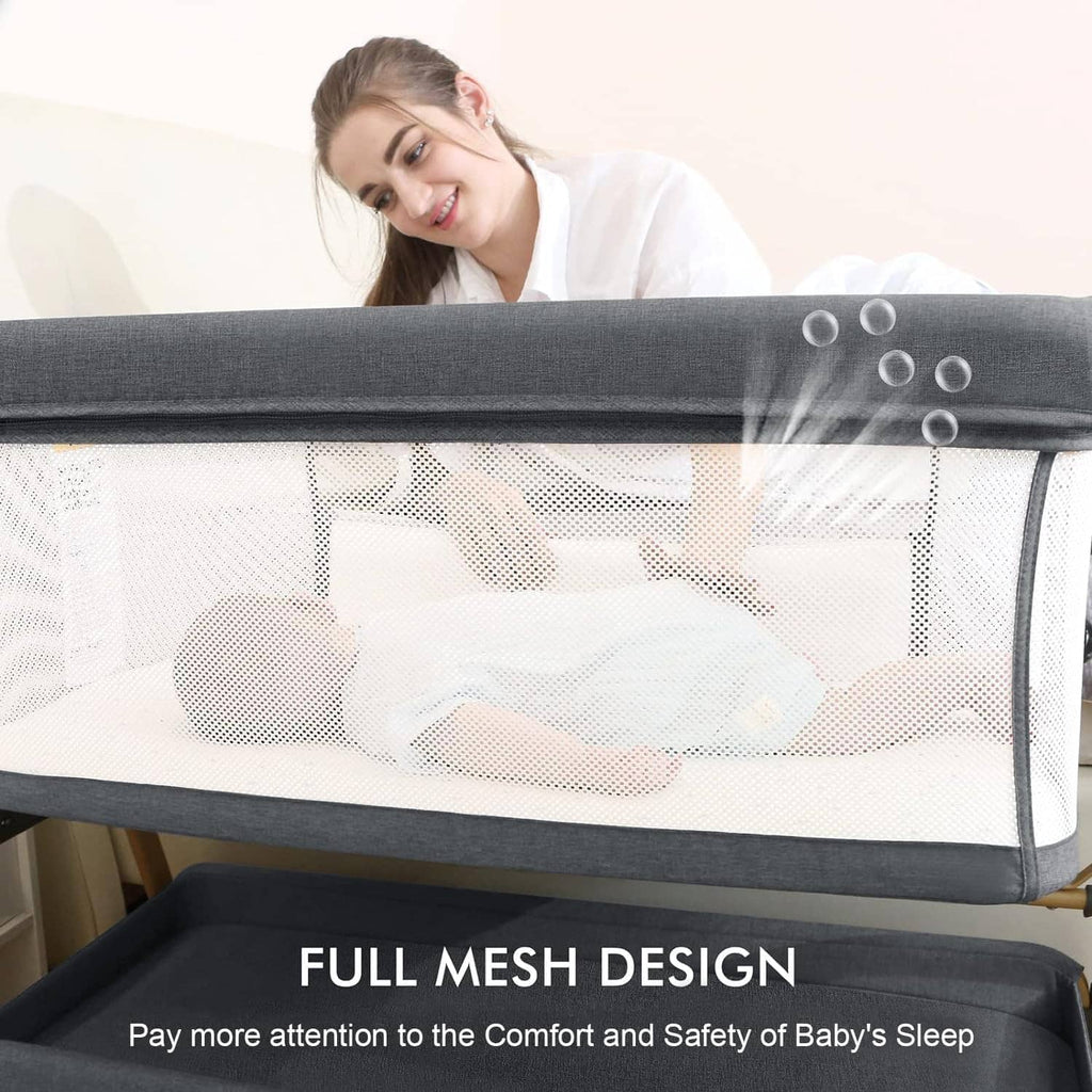 Close-up of baby bassinet white mesh sides and gray padded top rail.