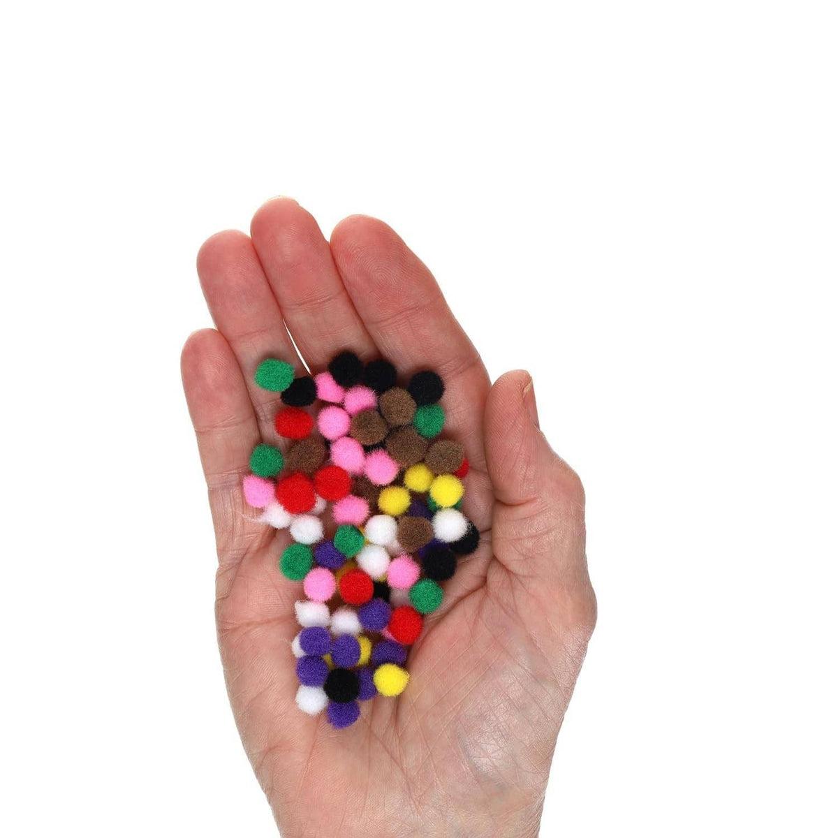Hand holding assorted small multicolor pom poms for crafts and kid activities