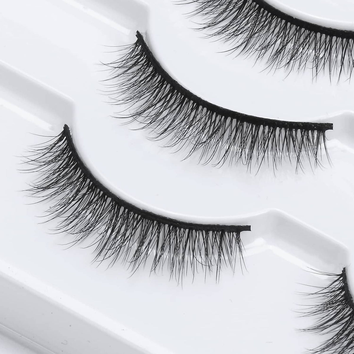 Black wispy false eyelashes on strip band with fine lash texture