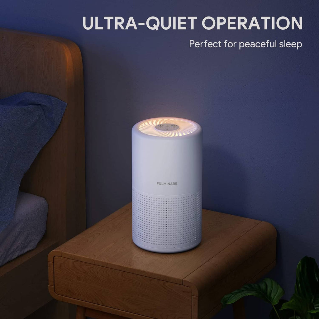 White air purifier with soft top glow on wooden nightstand and front perforated grille