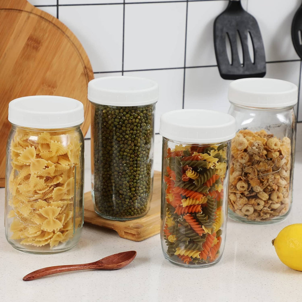 White wide-mouth mason jar lids on glass storage jars with assorted contents