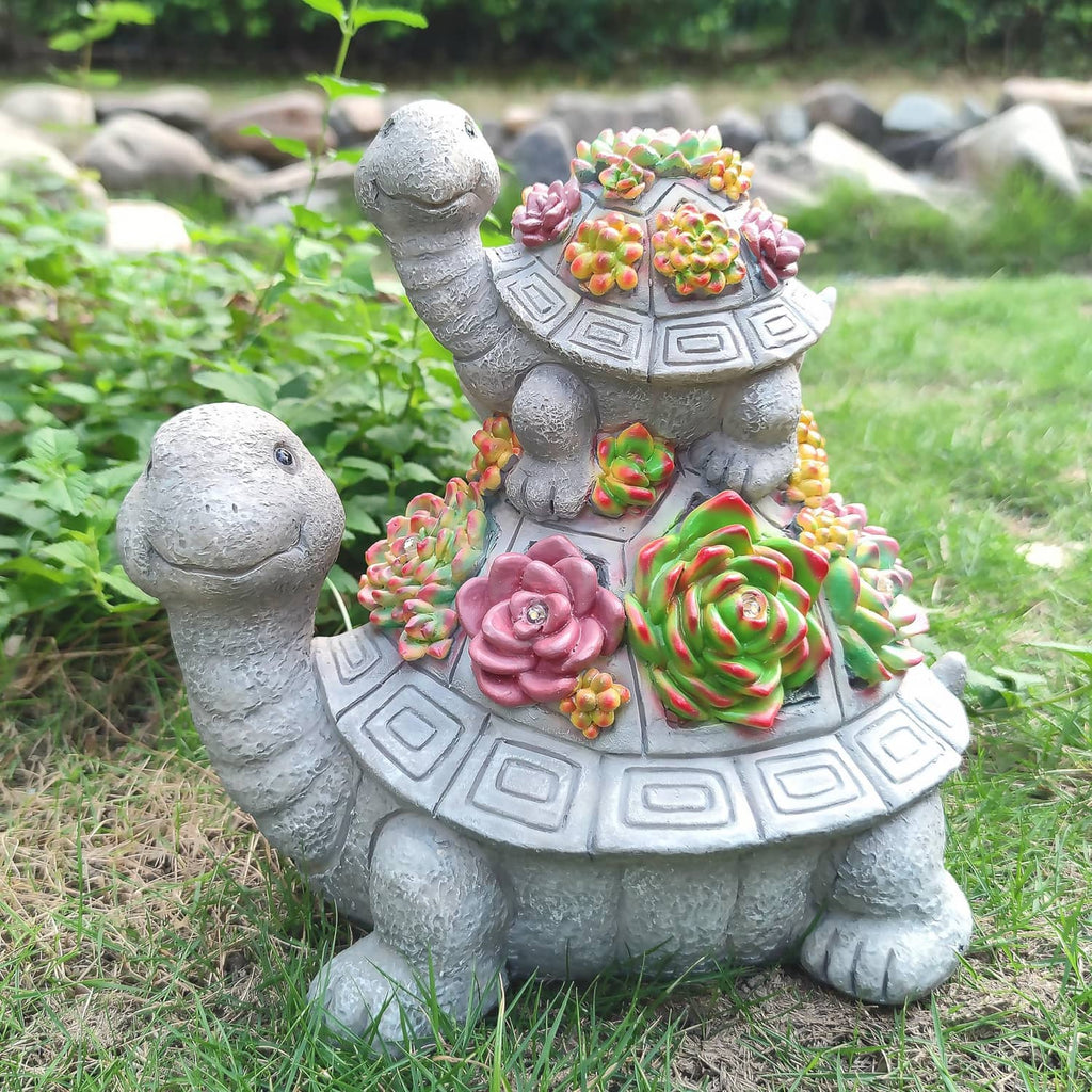 Solar tortoise garden lantern statue with colorful succulent-style flowers, no lights glowing