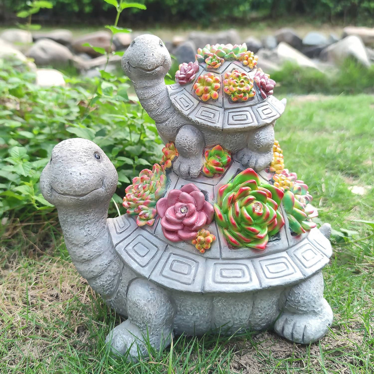 Solar tortoise garden lantern statue with colorful succulent-style flowers, no lights glowing