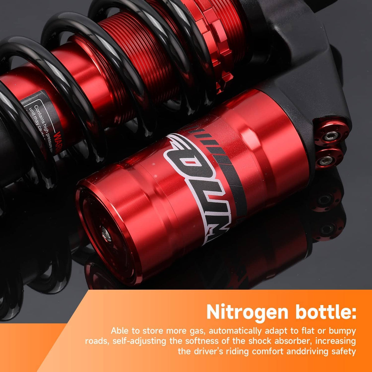 Close-up of red shock cylinder and black coil spring on a black mounting base