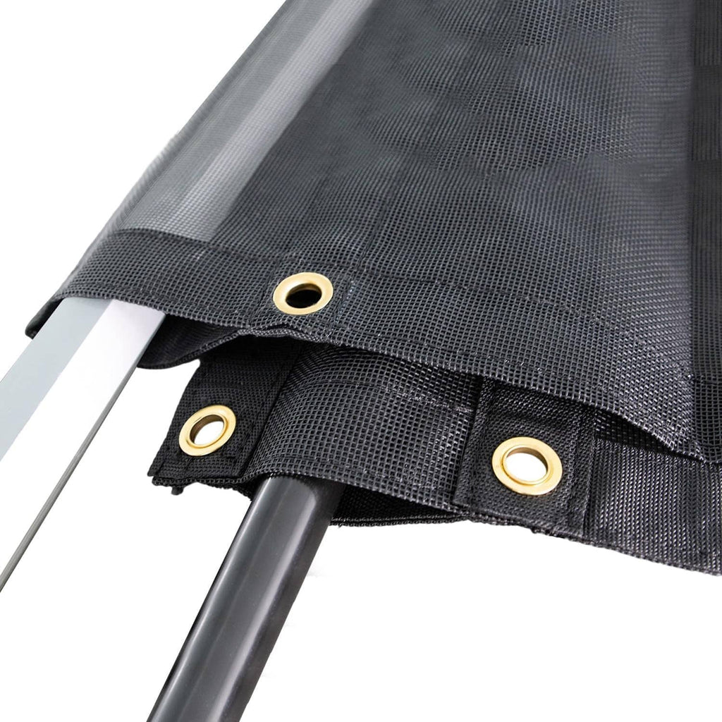 Black mesh tarp corner with reinforced seam and brass grommet eyelets