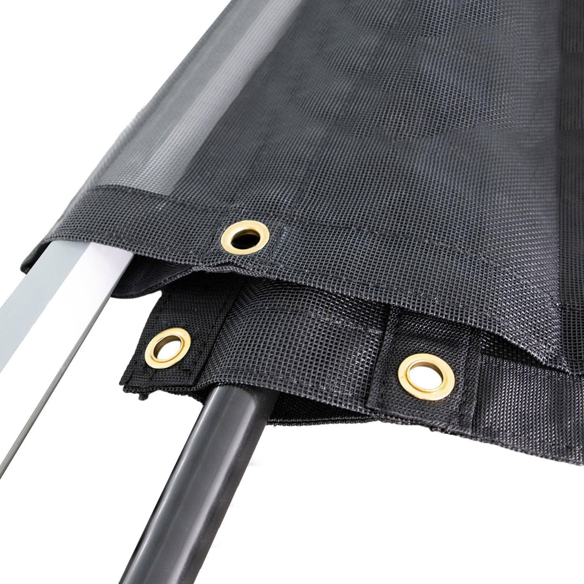 Black mesh tarp corner with reinforced seam and brass grommet eyelets