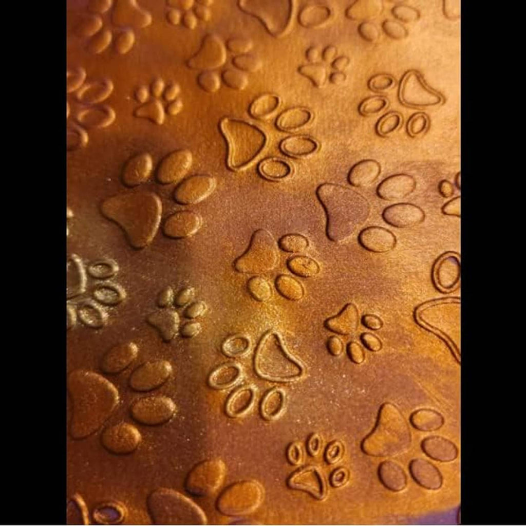 Close-up of embossed brown paw print pattern on plastic folder